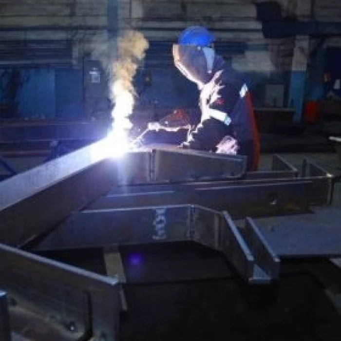 Welder works with metal structures