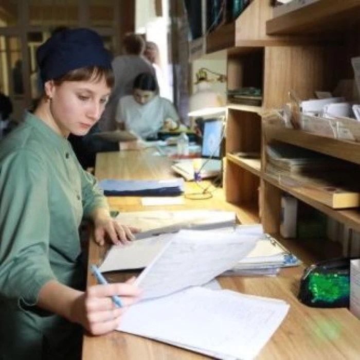 Woman in work uniform working with documents