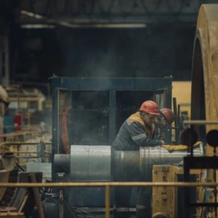 Steel plant worker operating industrial equipment