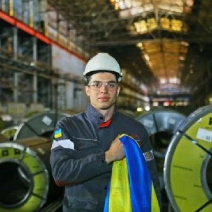 Steel plant worker holding a Ukrainian flag