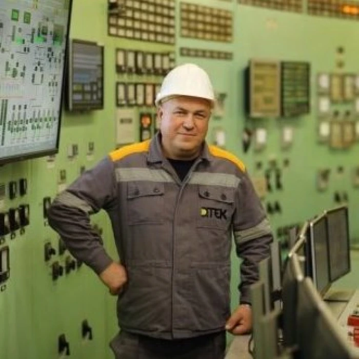 Power plant control room worker in a hard hat