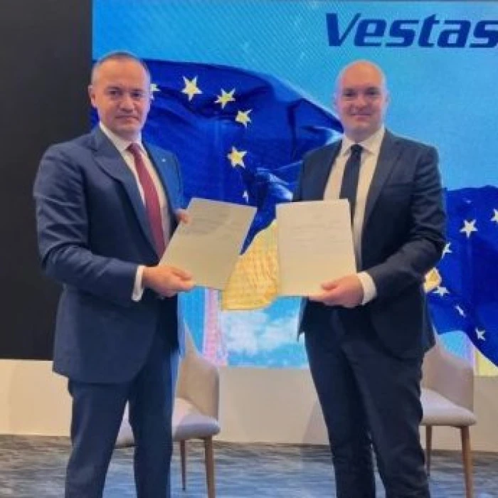 Document signing ceremony with Ukrainian and EU flags in the background