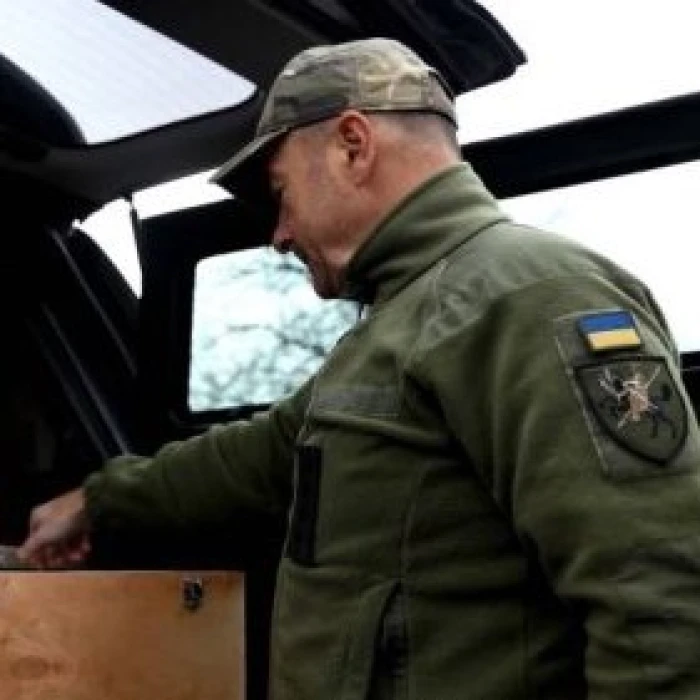 Ukrainian soldier near a military vehicle