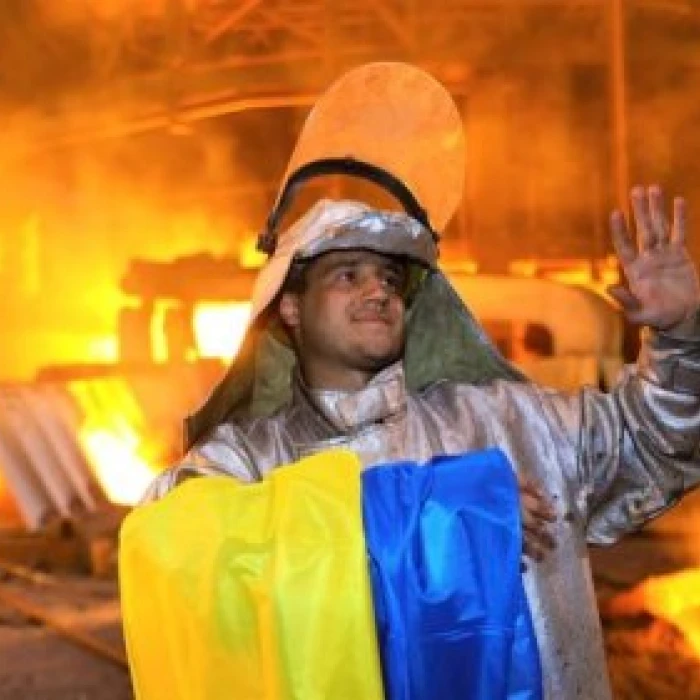 Steelworker with Ukrainian flag at steel plant