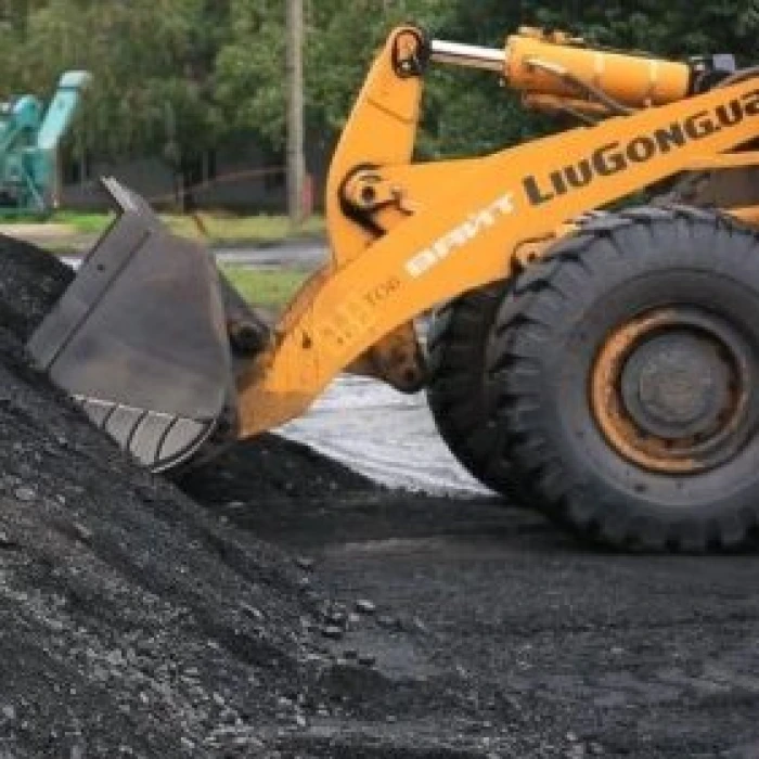 Front loader moving coal
