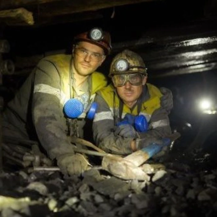 Coal miners in underground tunnel