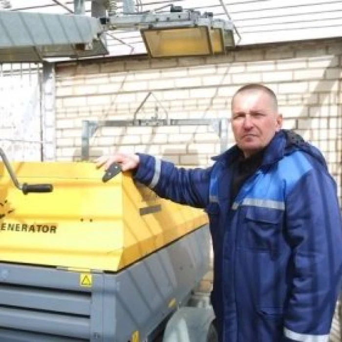 Worker next to power generator