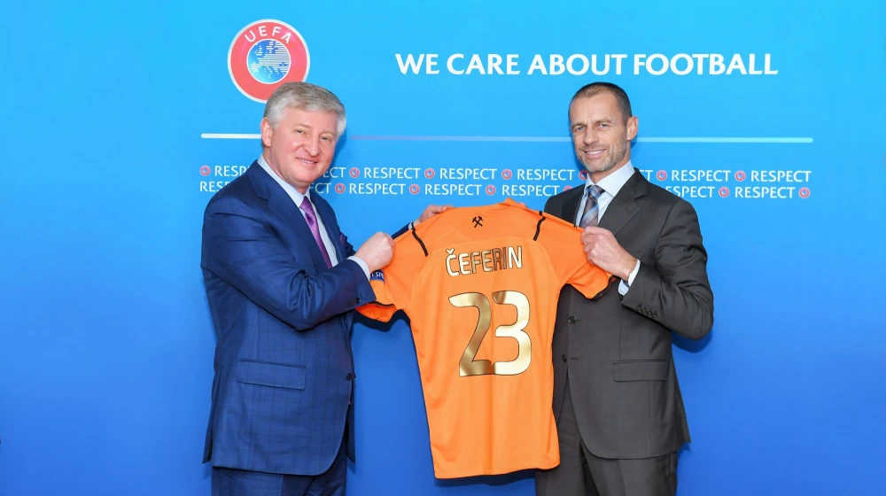 Men holding a football jersey with the inscription "CEFERIN 2"