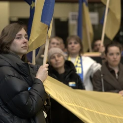 A girl with the flag of Ukraine at Mariupol. The Path of Memory and Dreams exhibition openning ceremony